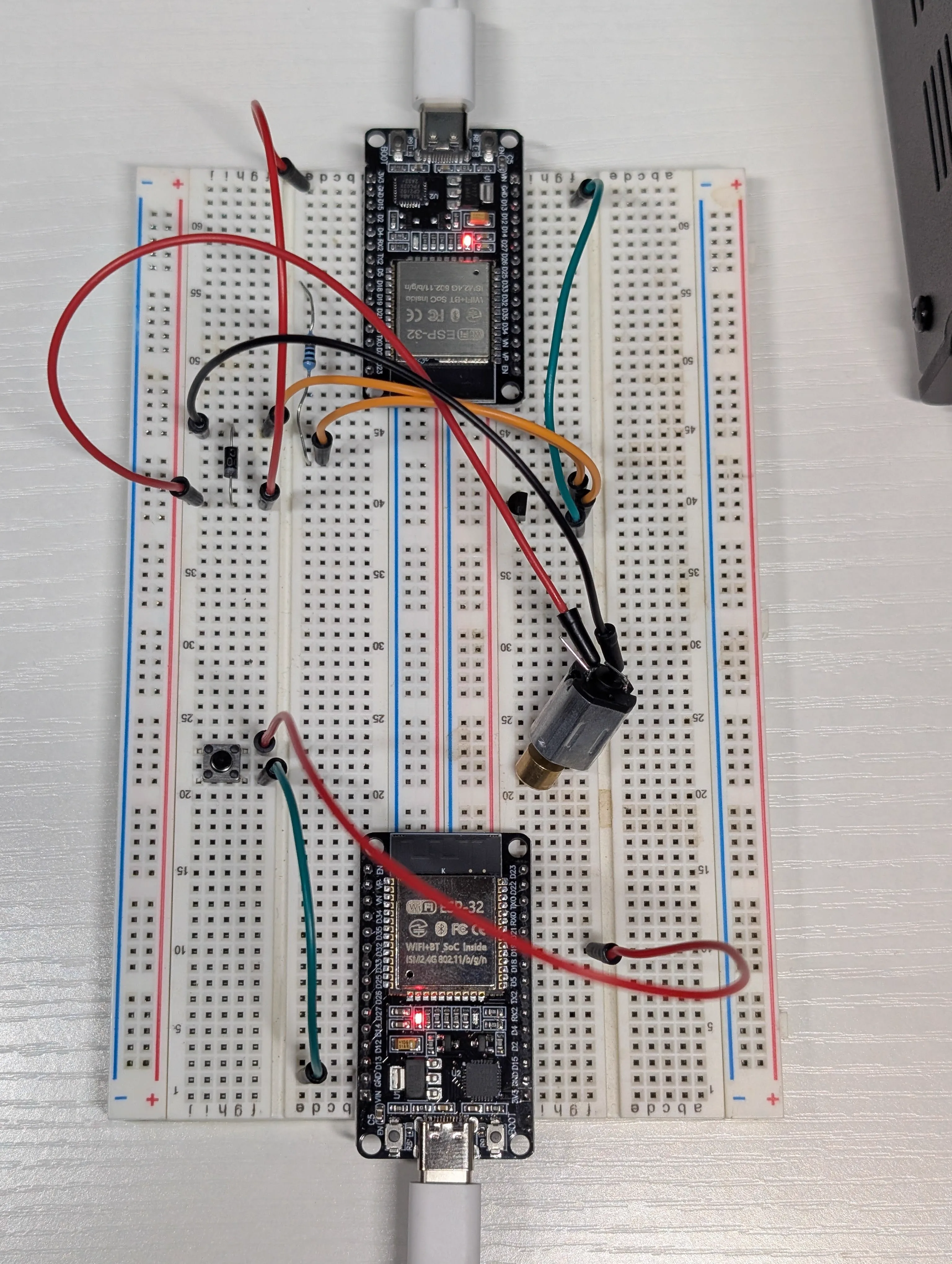 ESP32 two-node setup with vibration motor connected for full path validation
