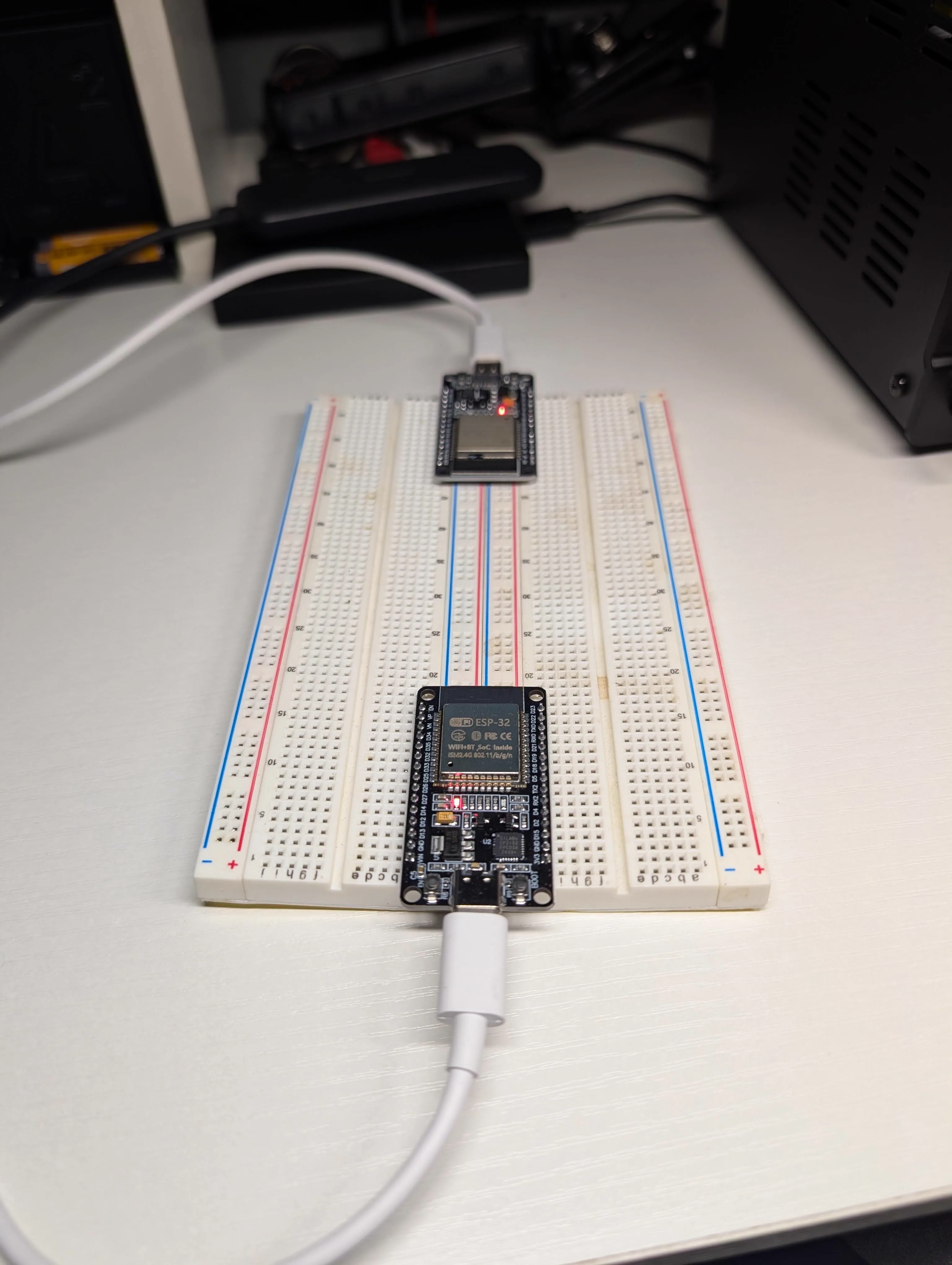 Two ESP32 boards connected over USB for side-by-side TX and RX development