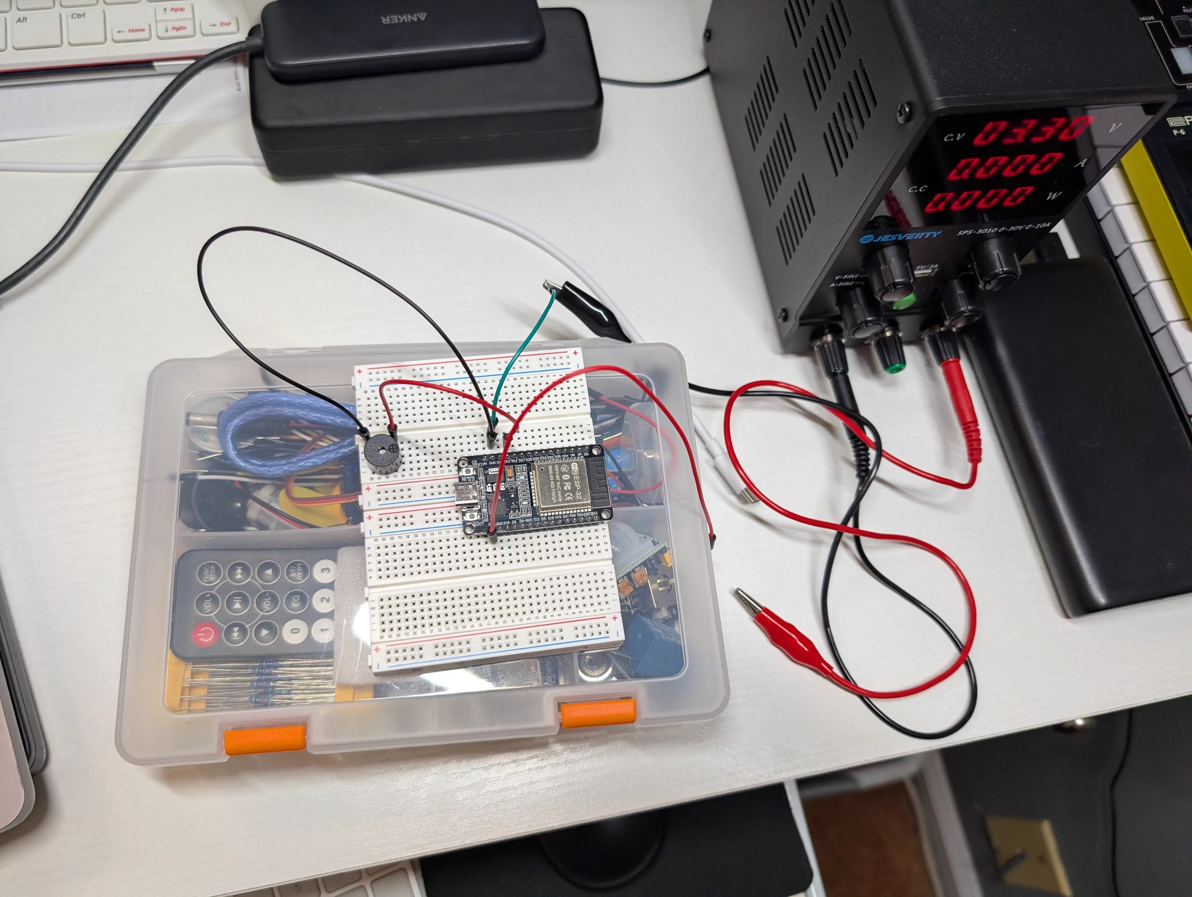 Bench setup for active buzzer test with ESP32 board and external power supply