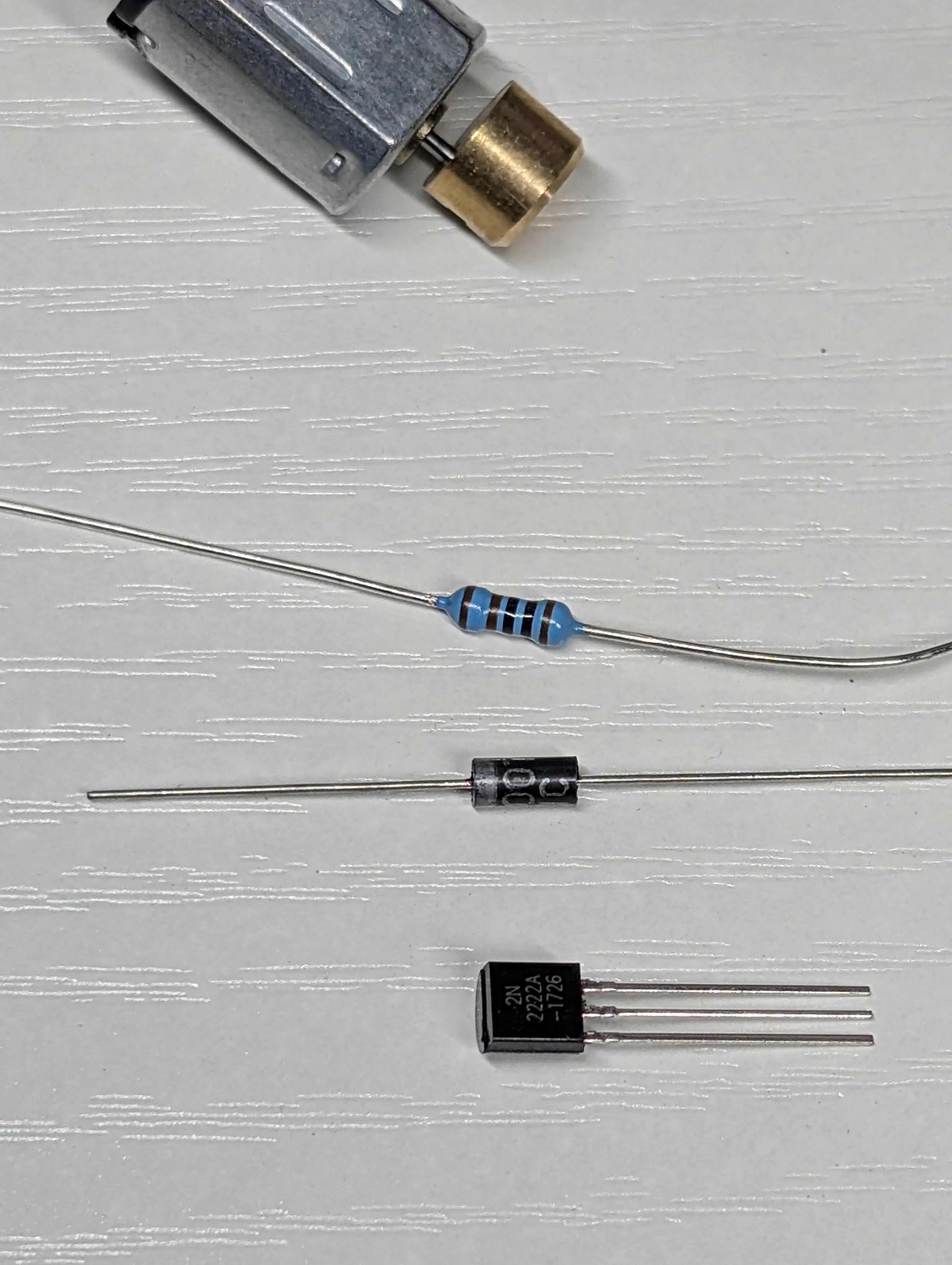 Motor driver components including transistor resistor diode and vibration motor laid out for assembly