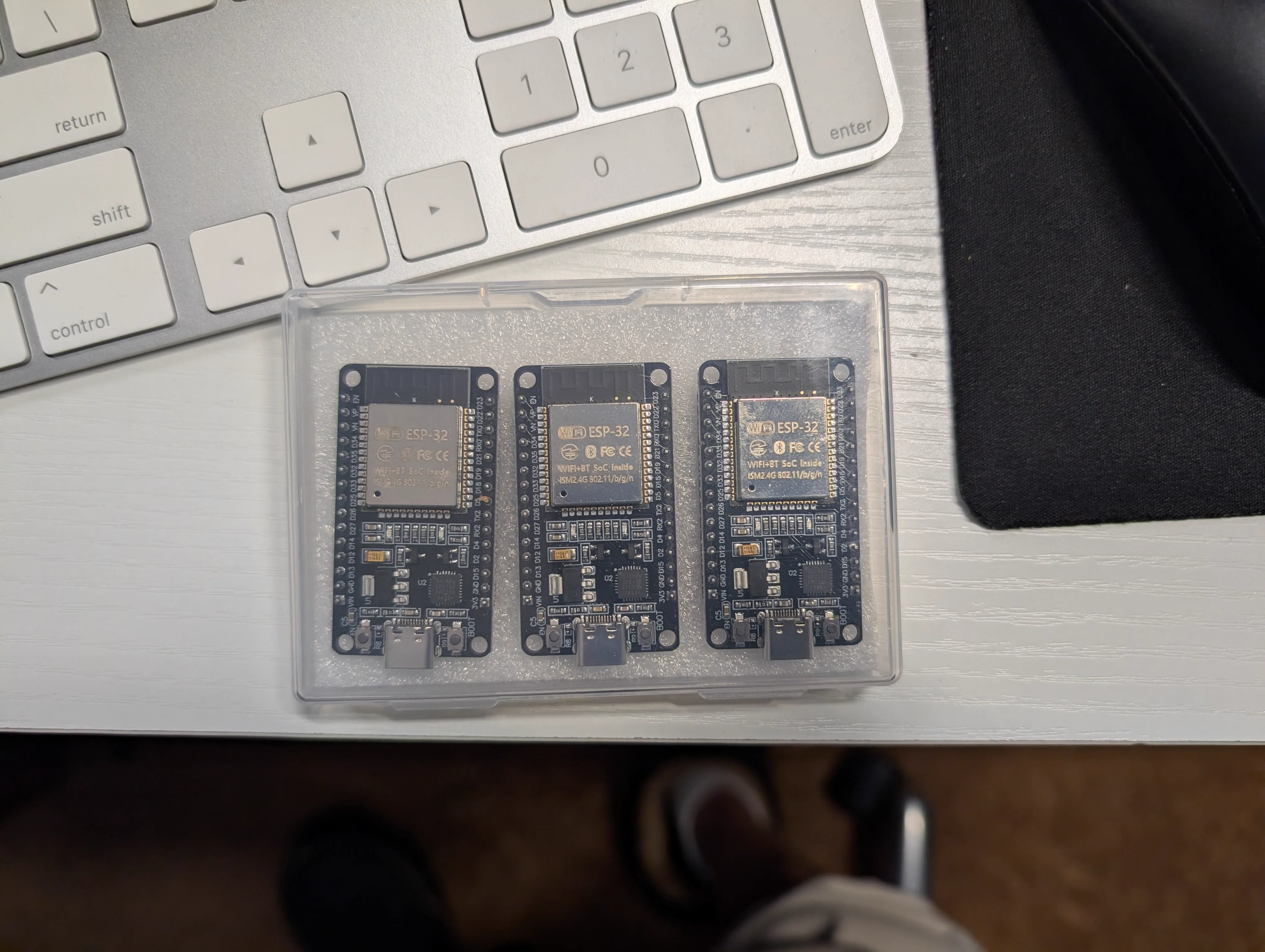 Three ESP32 development boards lined up for multi-node prototyping