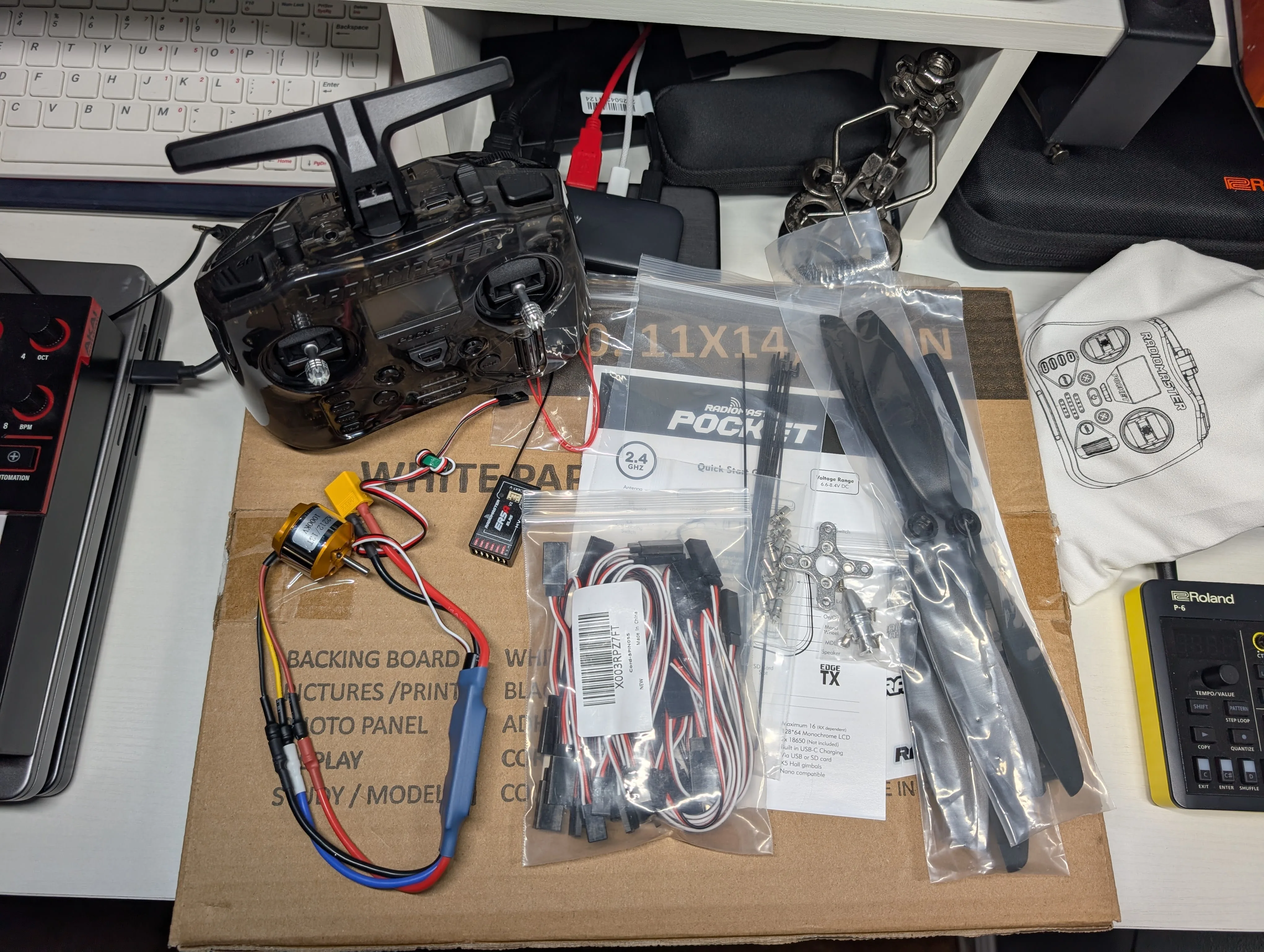 Close-up of RC components including servos, ESC, and wiring accessories