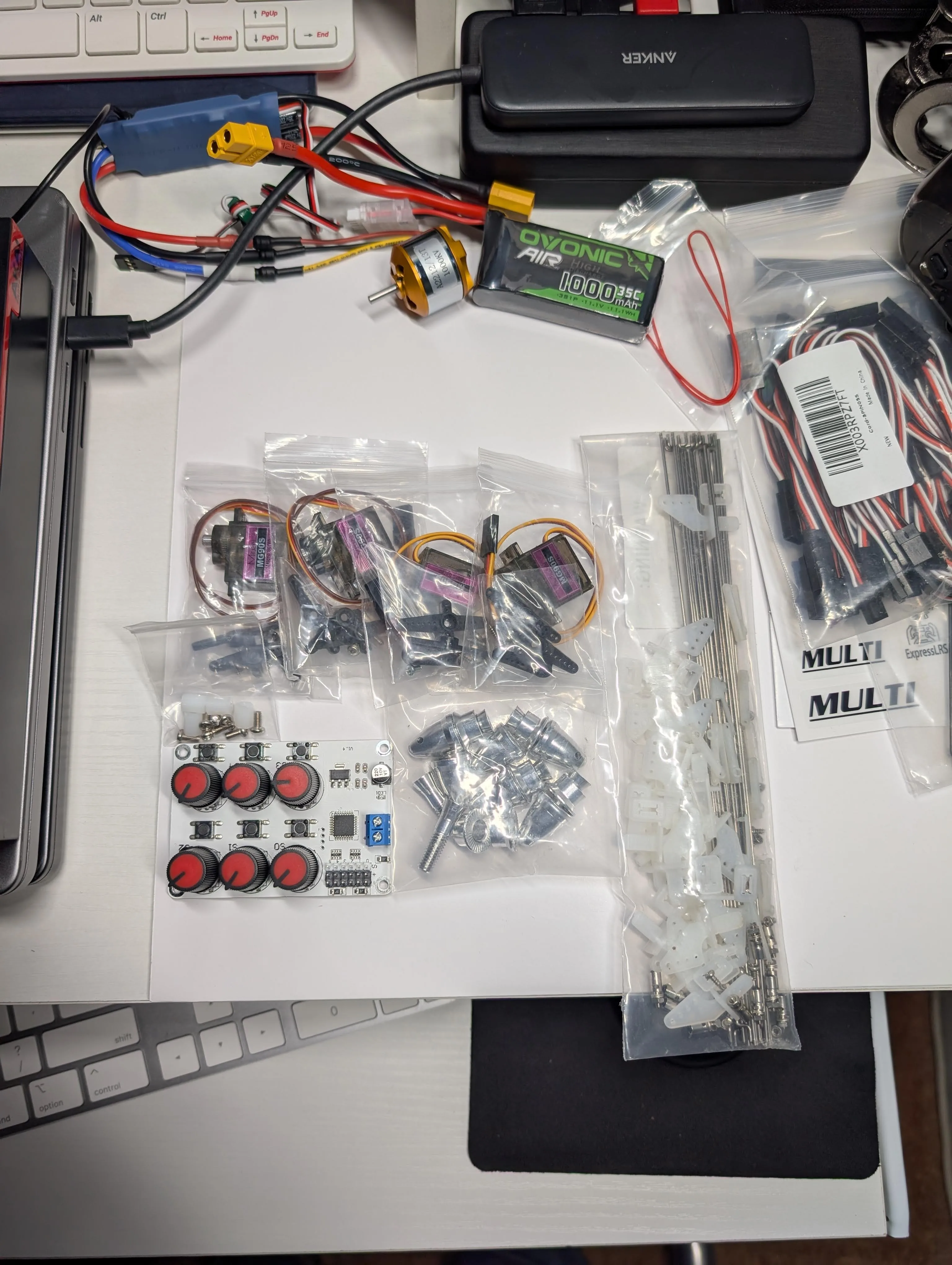 Additional fixed-wing components and accessories laid out for wiring and assembly