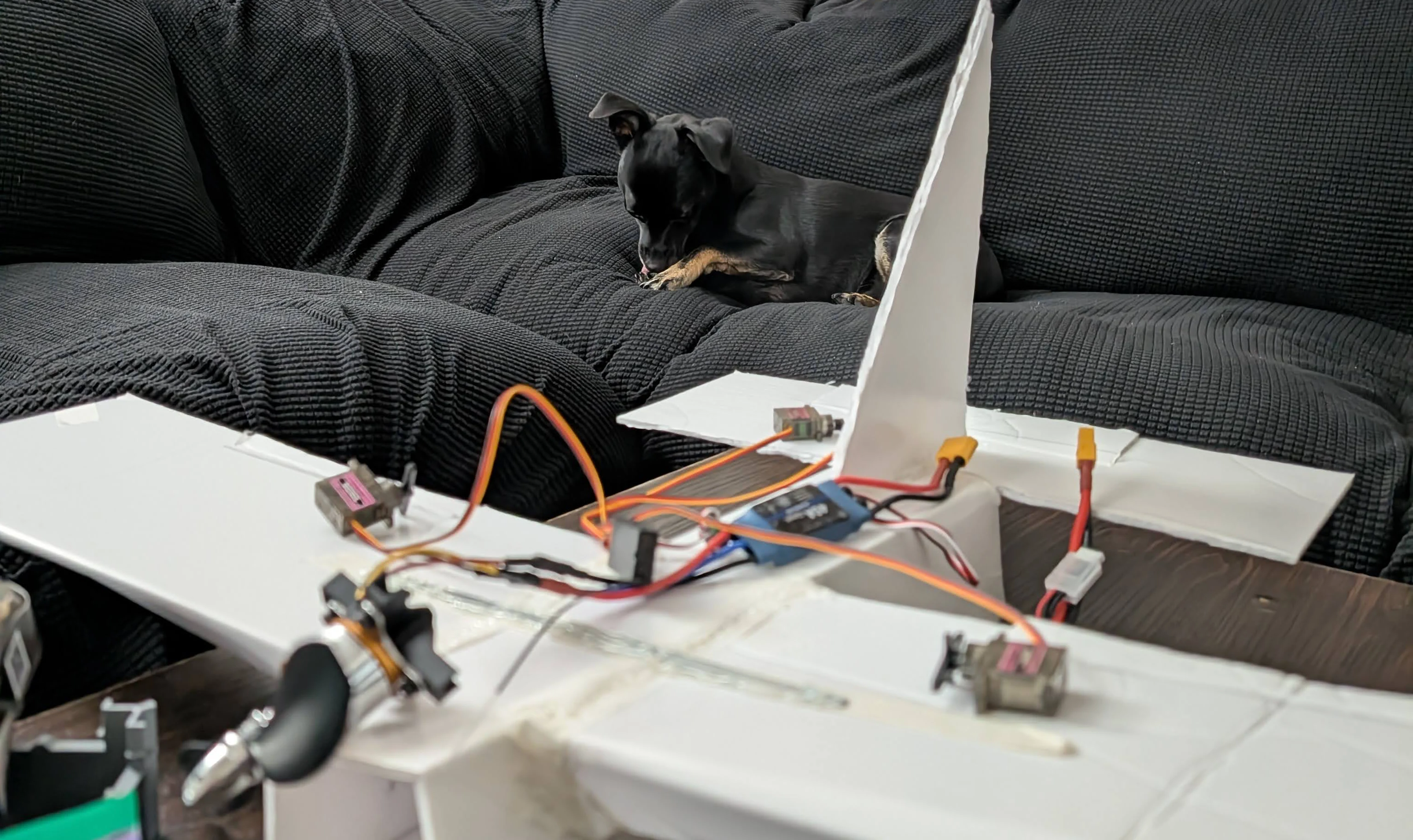 Raddad MKI foamboard plane with electronics installed on the bench
