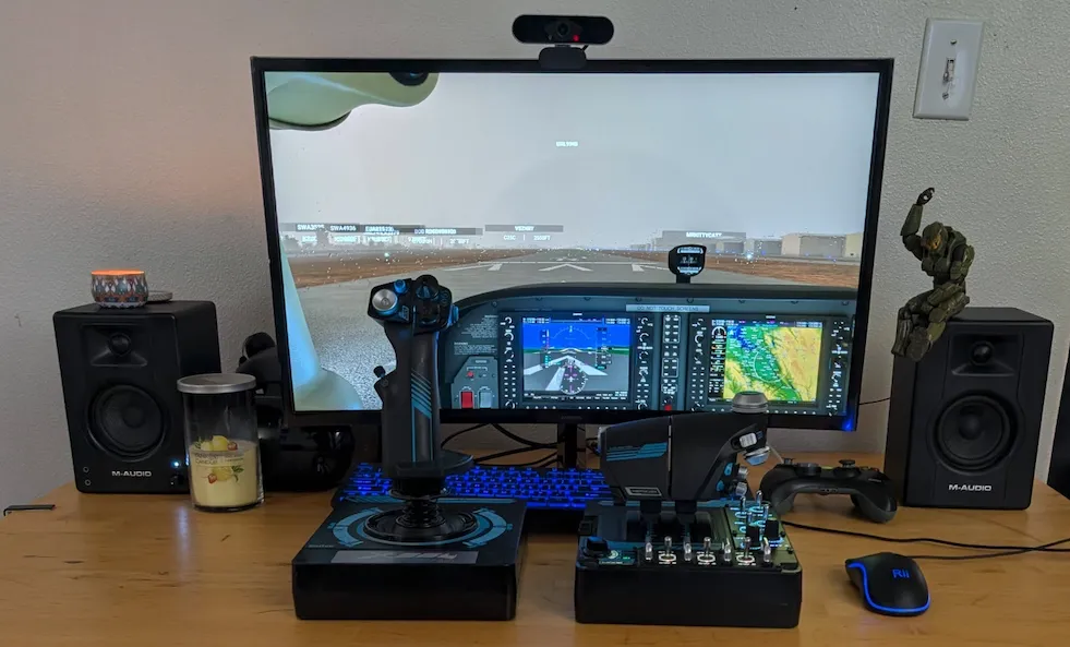 Wide view of desktop flight simulator setup with monitor and controls