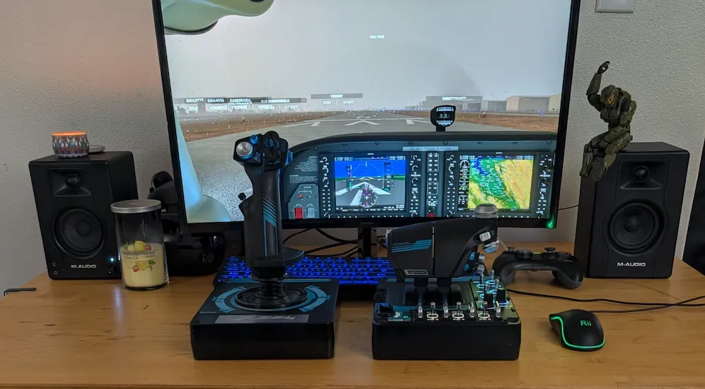 Home flight simulator setup with monitor, yoke, and flight controls