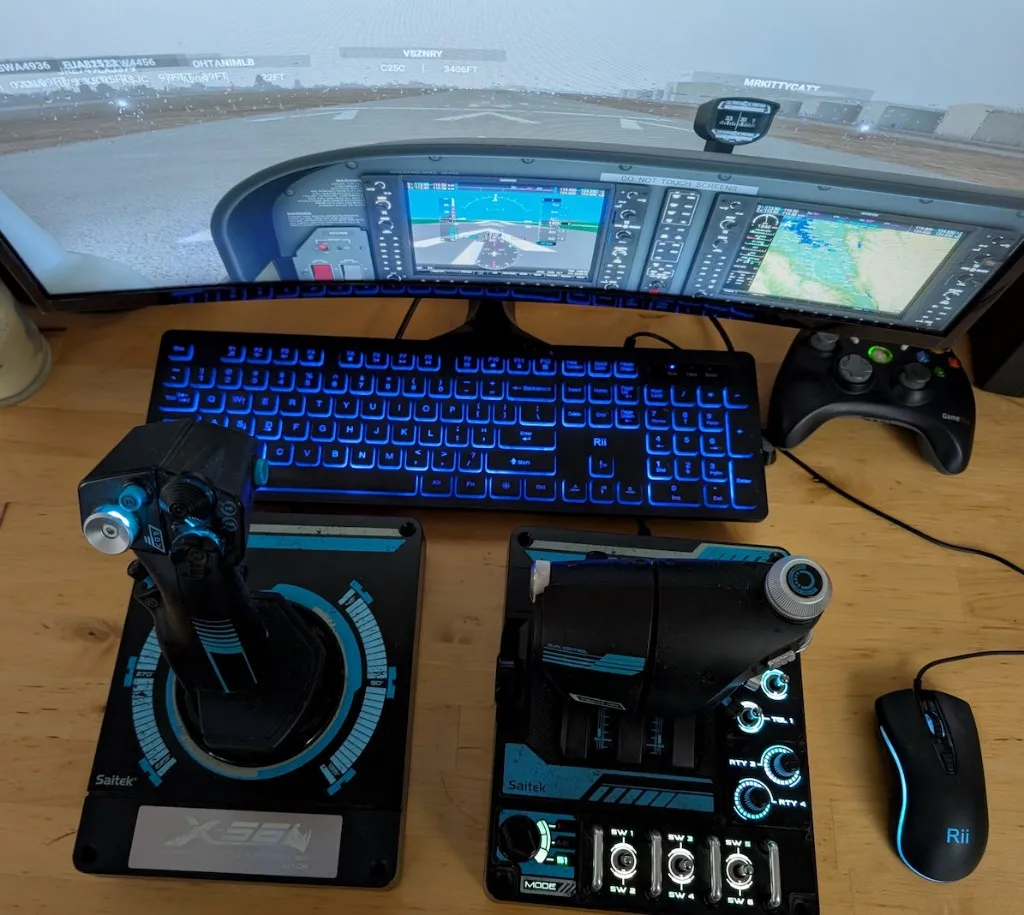 Top-down view of joystick and throttle next to keyboard and monitor