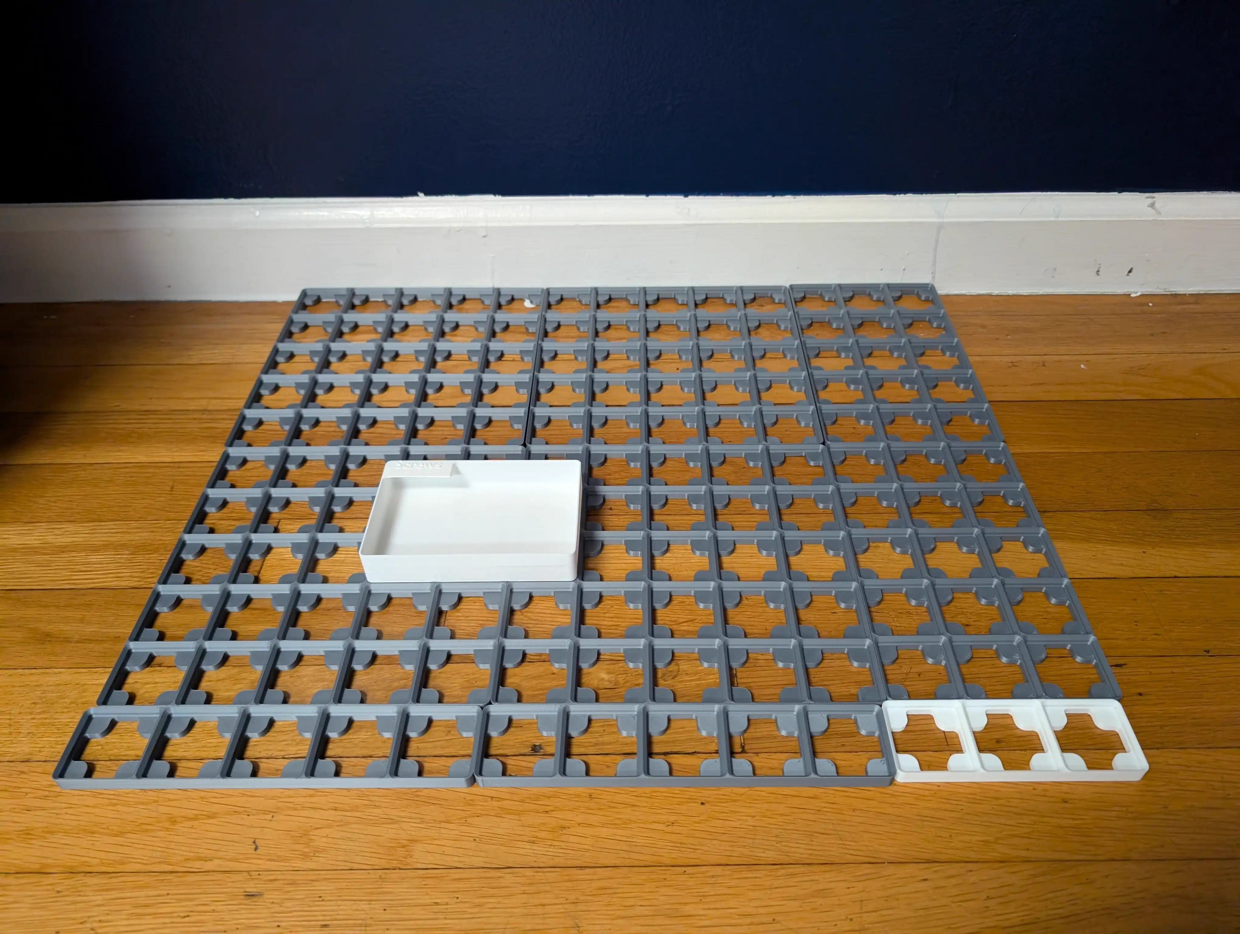 Baseplates laid out on floor with one sample bin positioned for testing