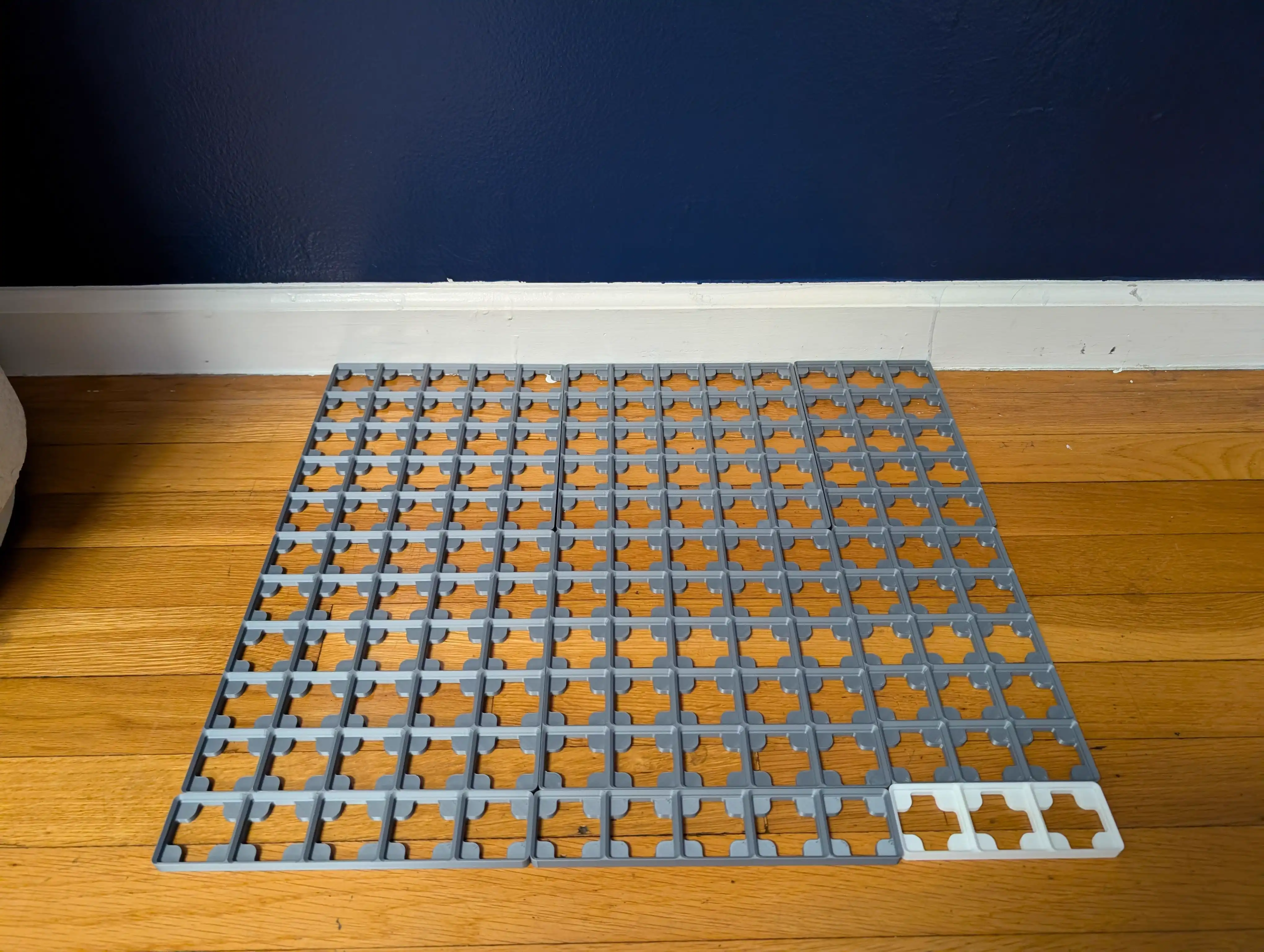 Gridfinity baseplates laid out on the floor before installation