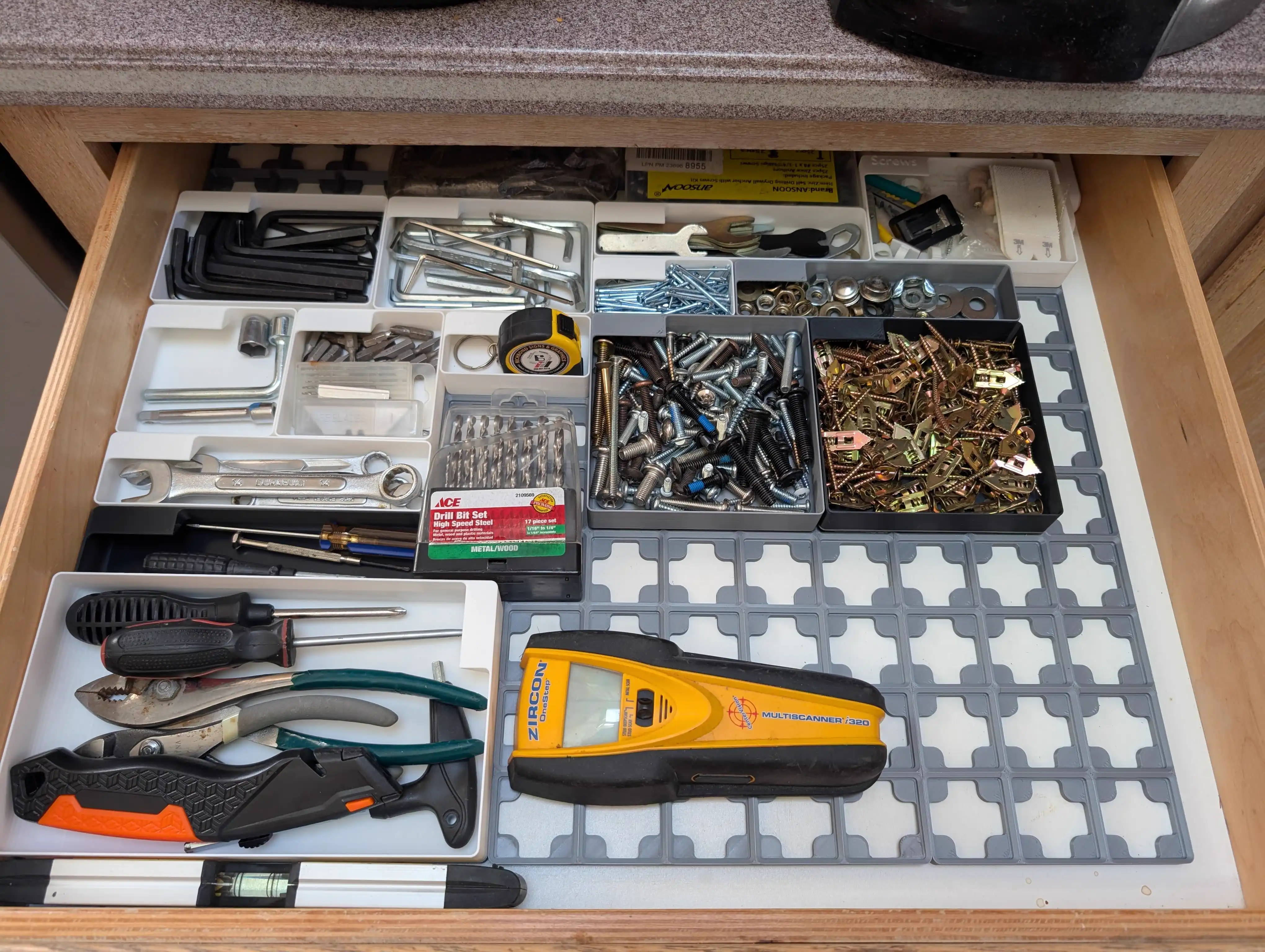 Gridfinity junk drawer organization with tools and hardware in modular bins