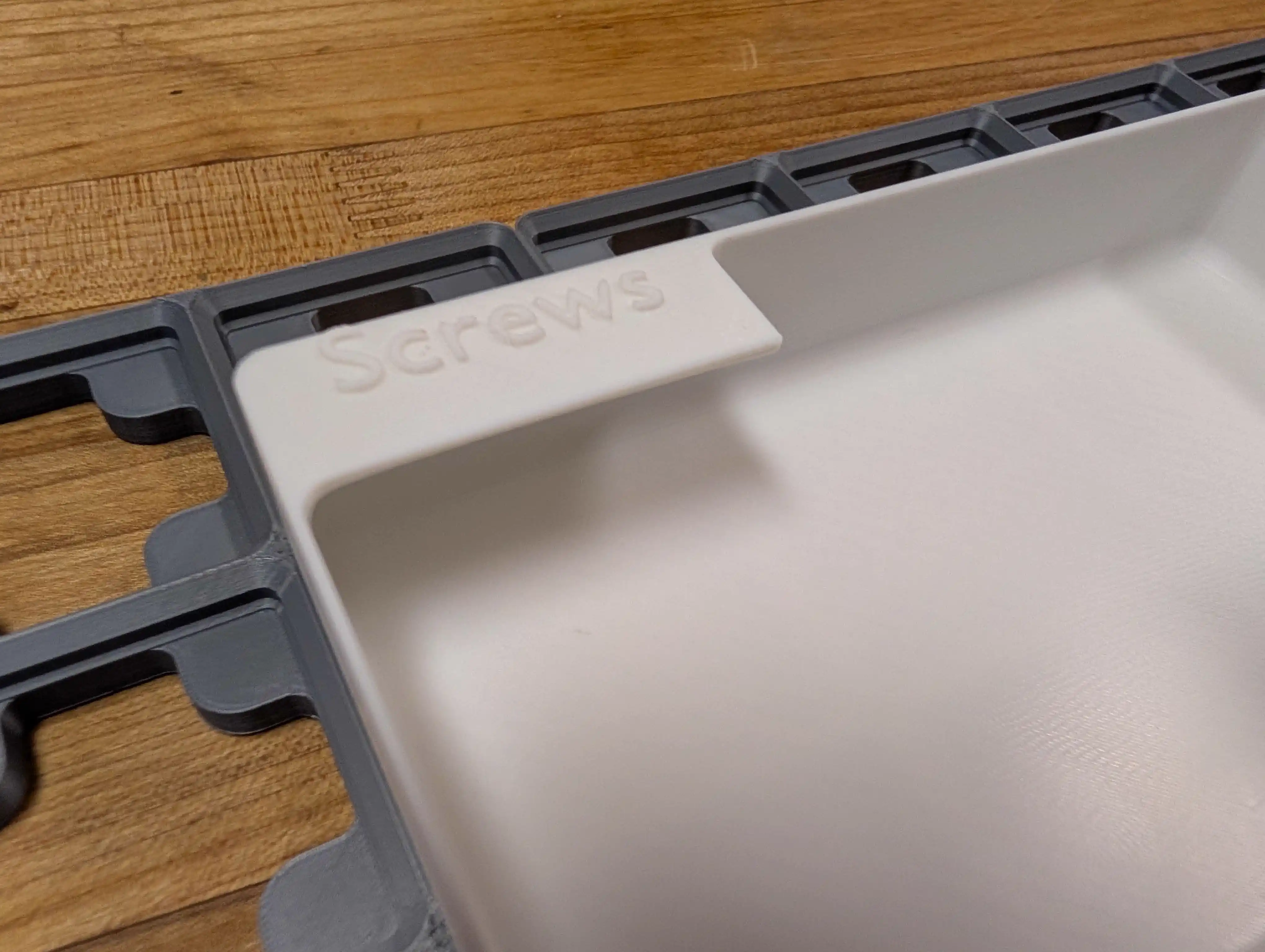 Closeup of labeled tab on screw storage bin