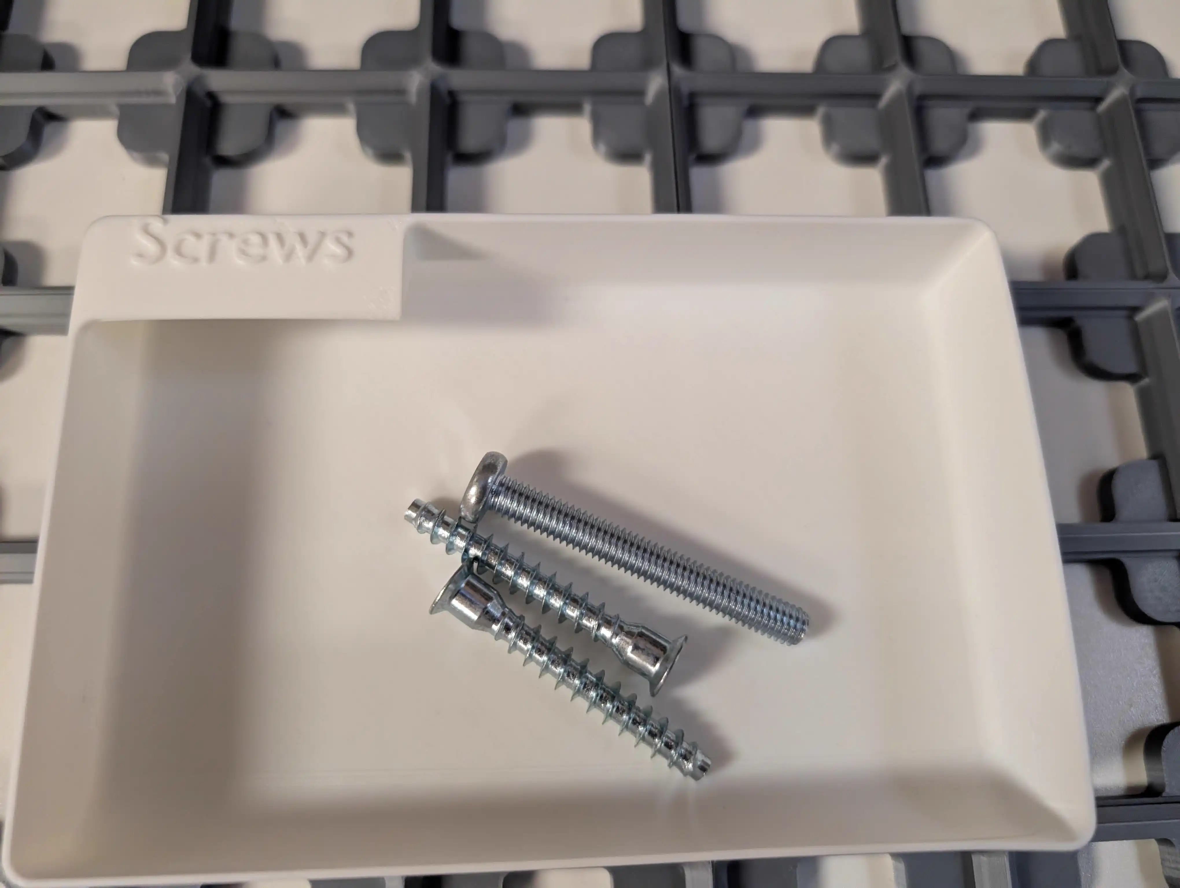 Closeup of early screw bin test in Gridfinity drawer layout