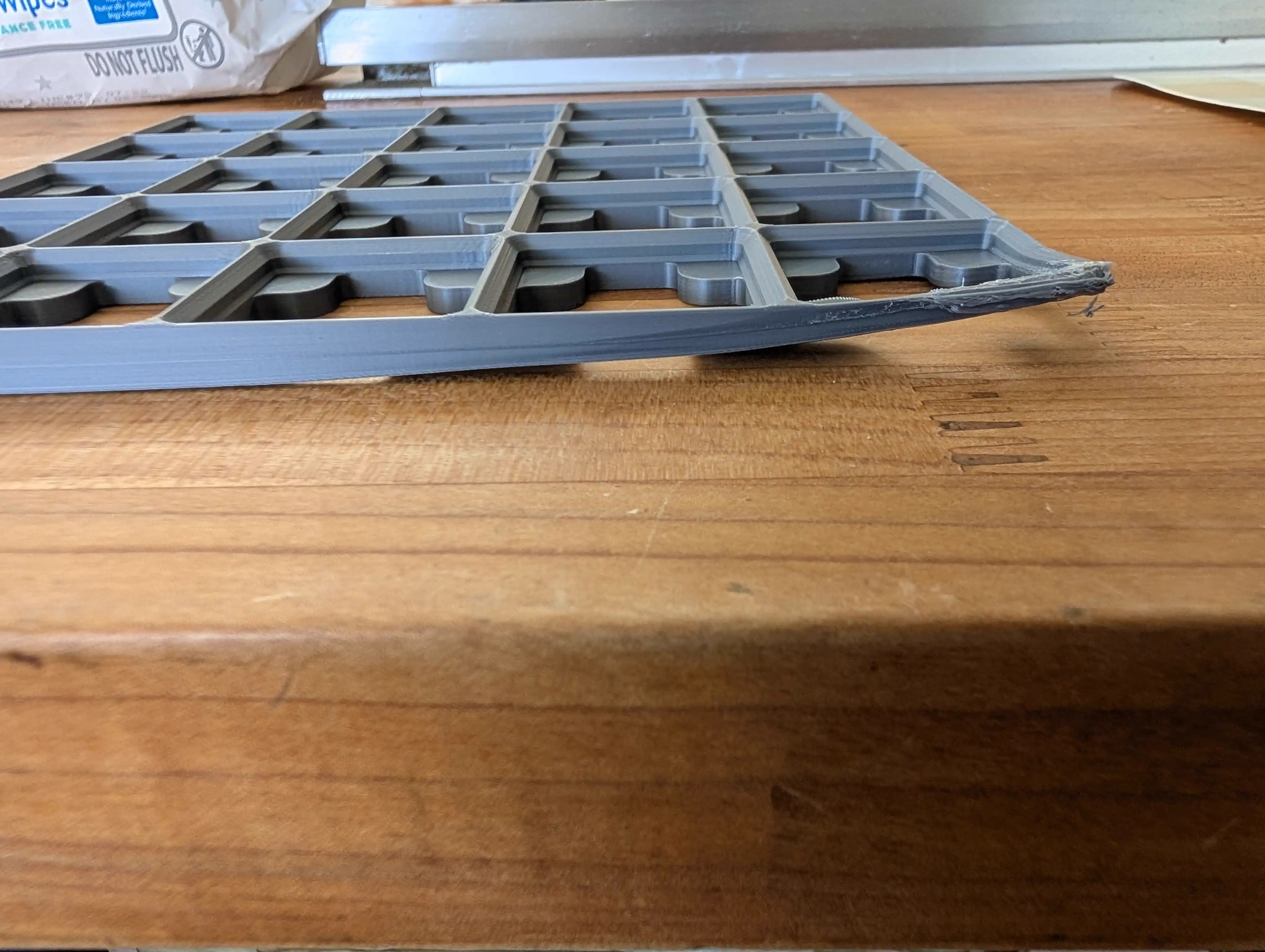 Side view showing warped edges on Gridfinity baseplate print