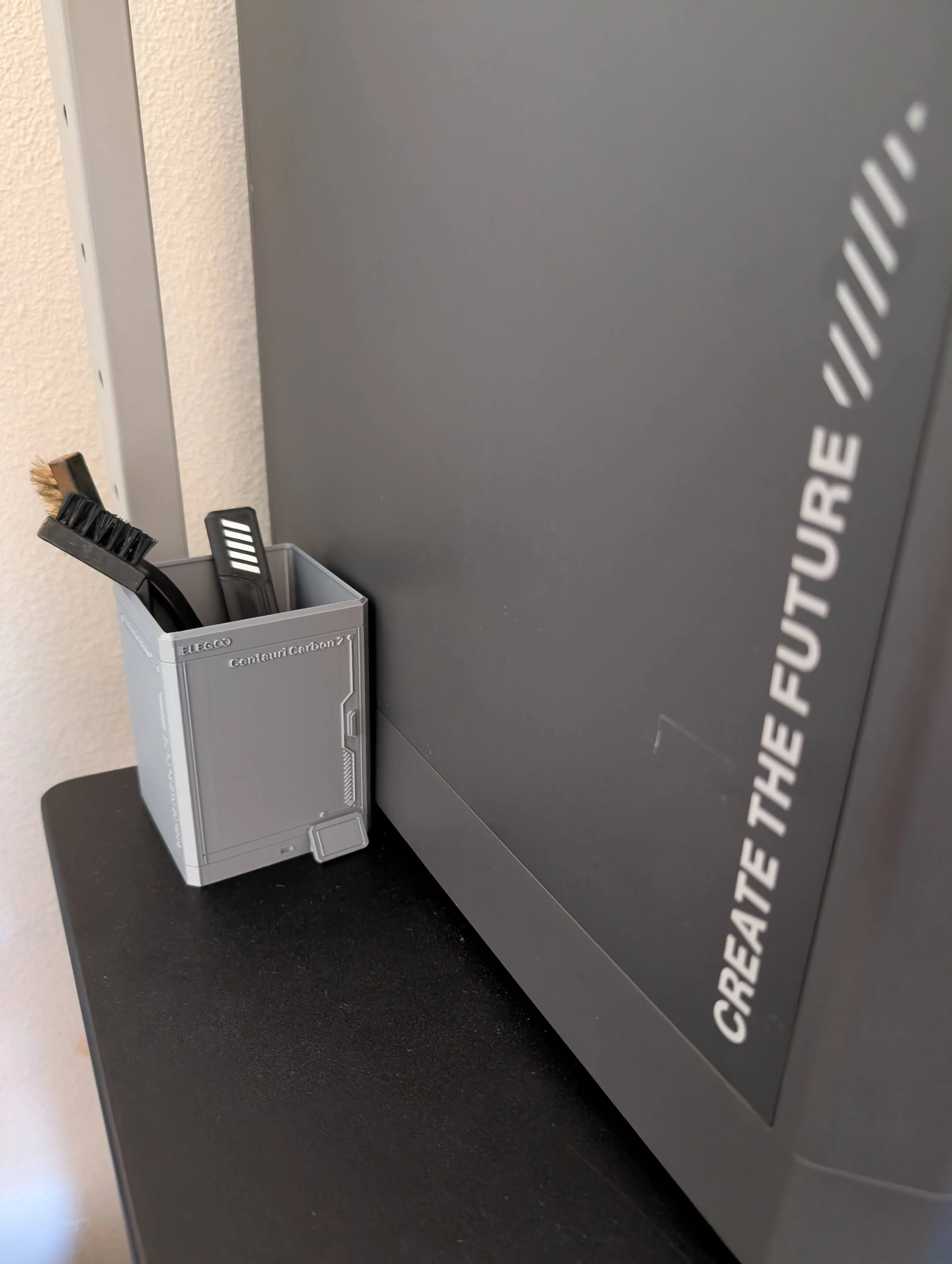 3D-printed miniature printer-shaped toolbox holding printing tools