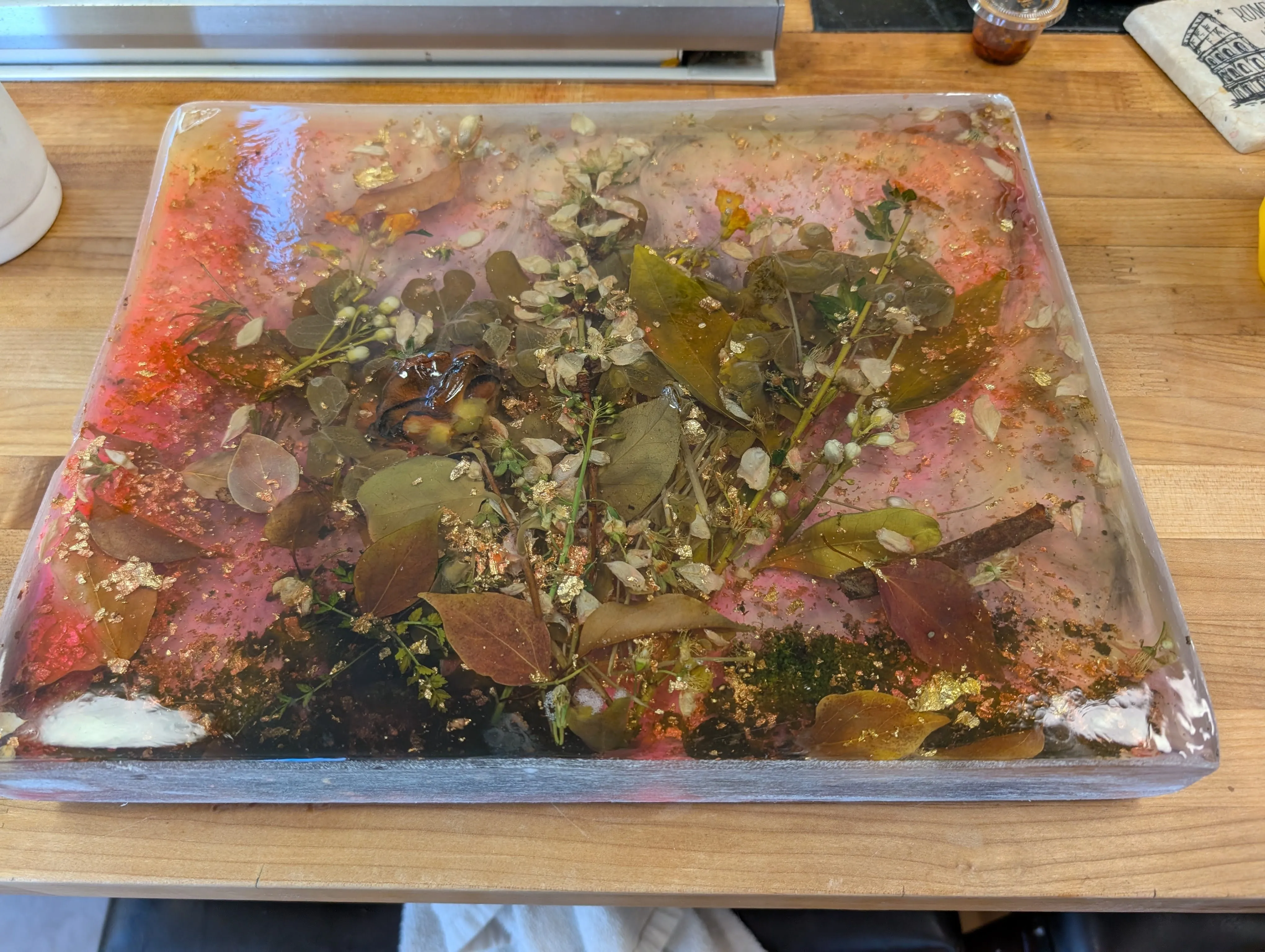 Epoxy art piece with edges sanded smooth, showing the embedded flowers clearly