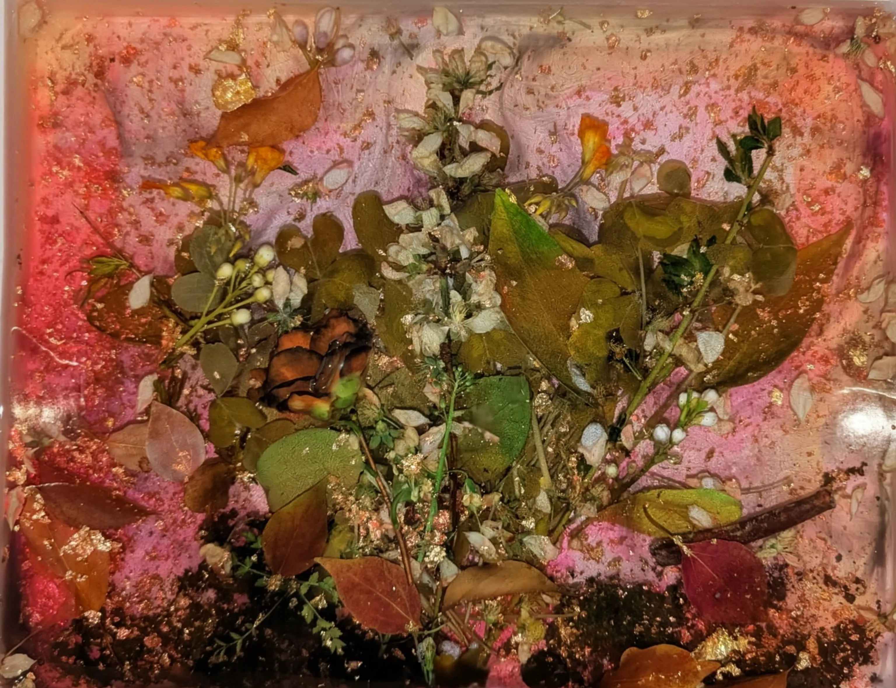 Final epoxy pours nearly covering all the flowers with just a few petals poking through