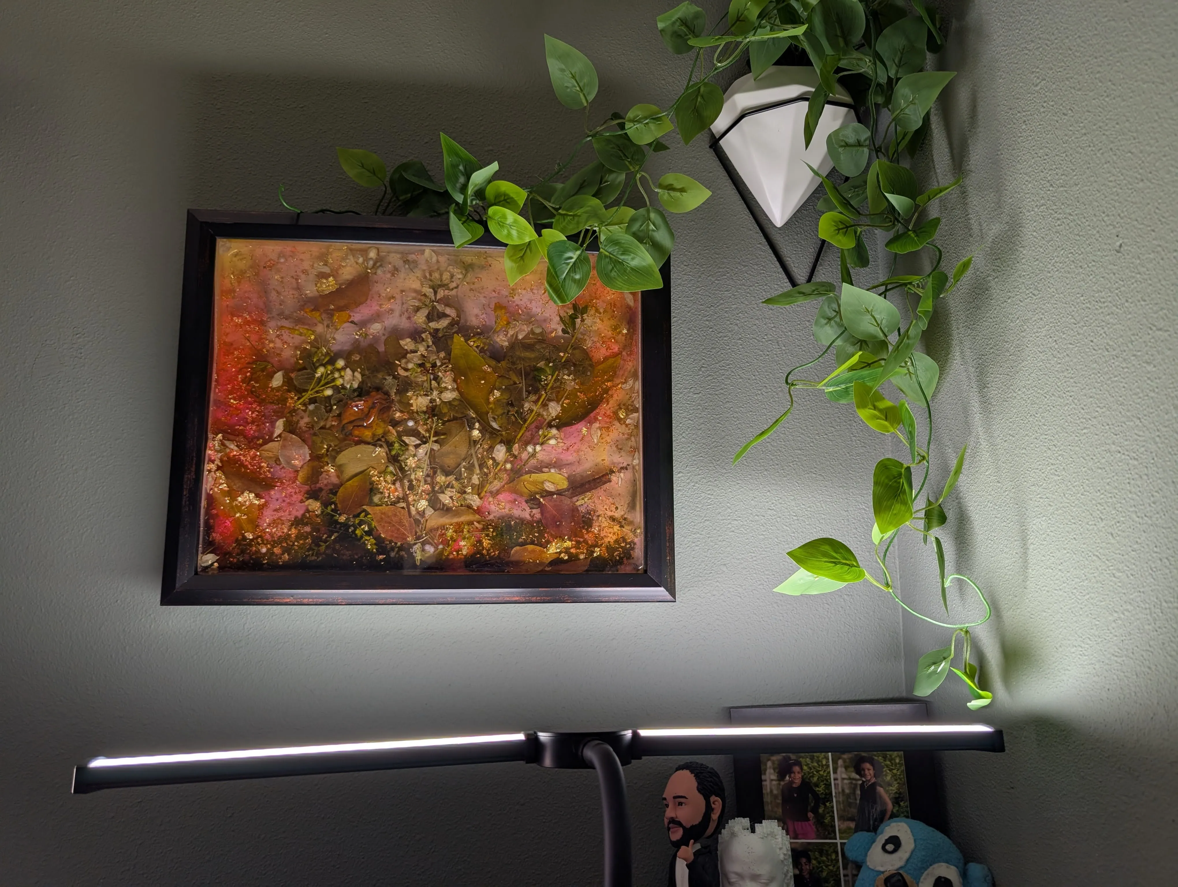 Wider view of the desk setup with Mulberry Spring '26 and a hanging plant