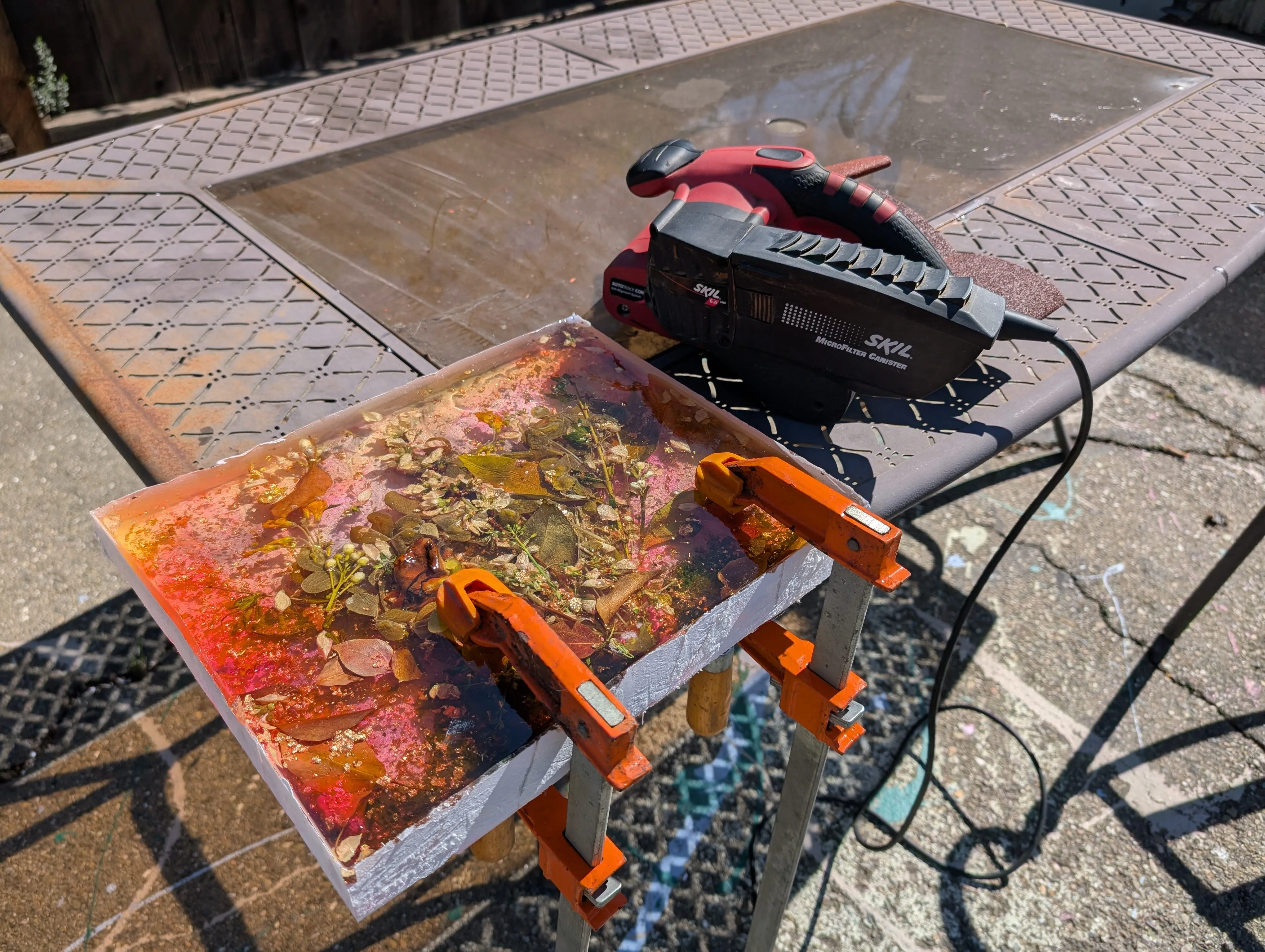 Setting up the cured epoxy piece on a work surface for edge sanding