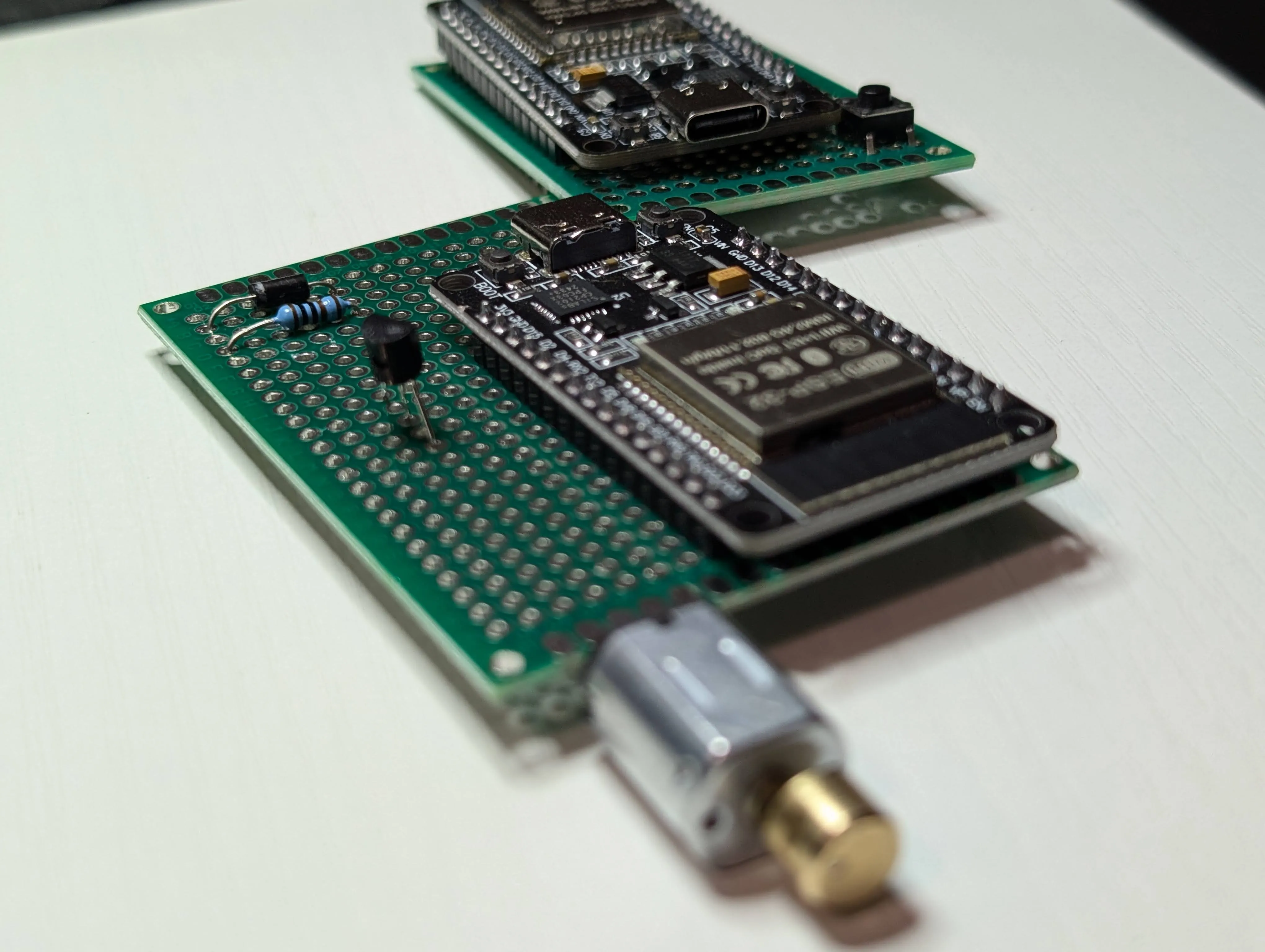 ESP32 RX board mounted on perfboard with buzzer and motor components