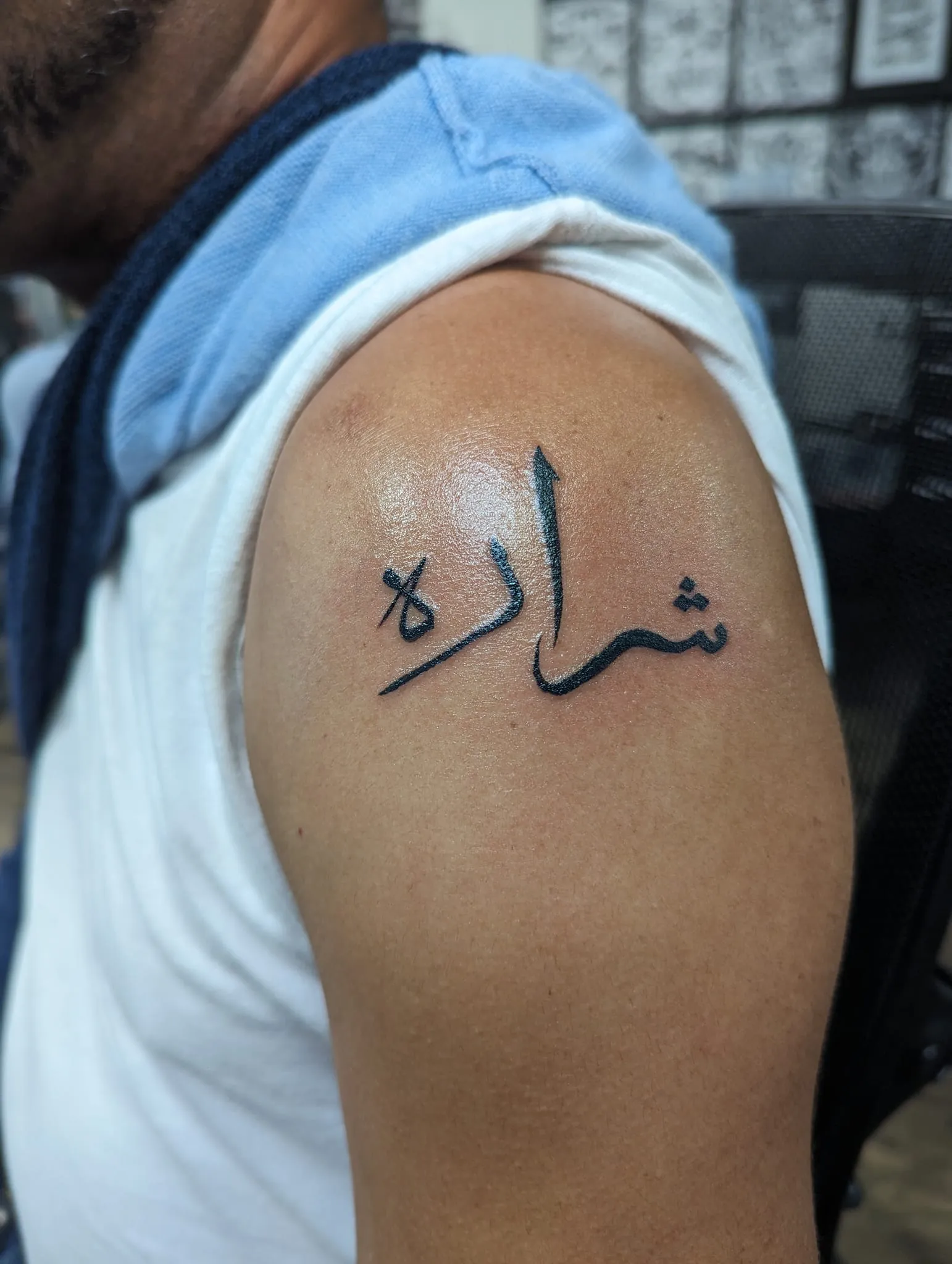 Tattoo of a name written in Farsi script on Warren's arm