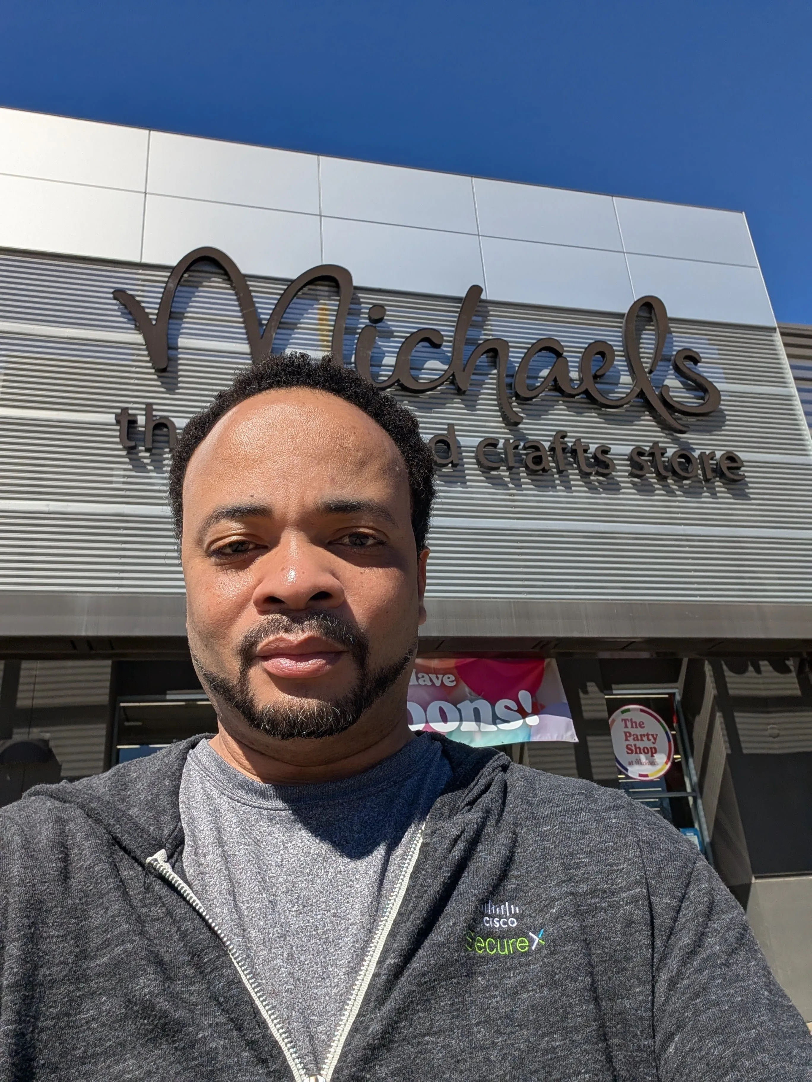 Warren Blackwell at Michael's craft store holding the epoxy art piece