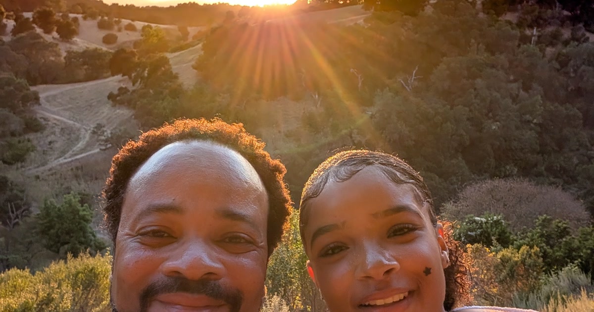 Warren Blackwell and his daughter together at sunset